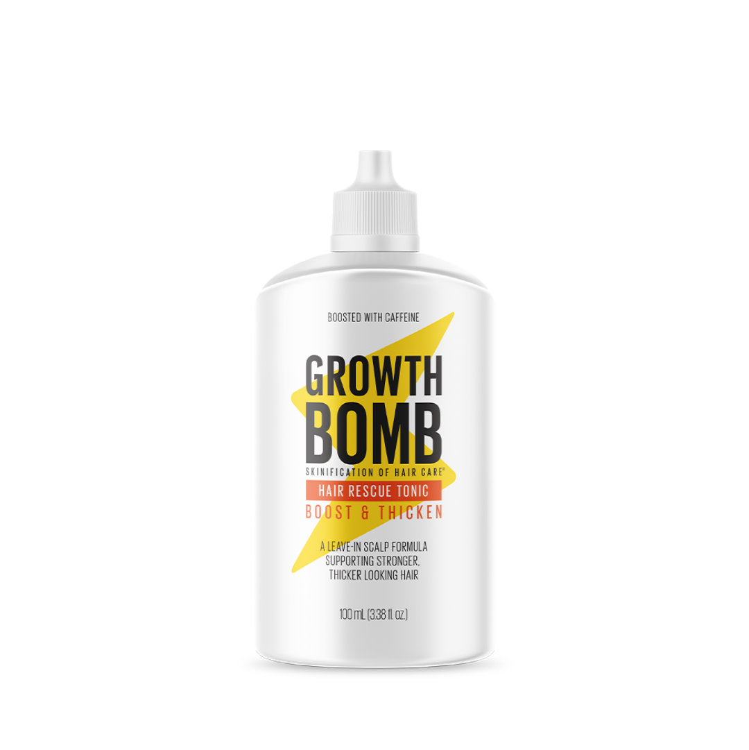 The image shows a white bottle of the Hair Rescue Tonic from Growth Bomb, featuring bold black and yellow text on its label. The tonic has a caffeine-boosted formula for improved scalp condition and stronger hair, with the bottle containing 100 mL (3.38 fl oz).