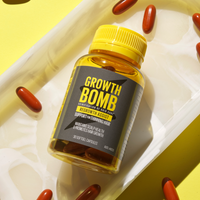 A bottle of Regrowth Assist Support for Thinning Hair Supplement by Growth Bomb US rests on a white tray surrounded by brown capsules. Its label promises to enhance hair thickness, while a vibrant yellow background energetically highlights its focus on revitalizing hair growth.