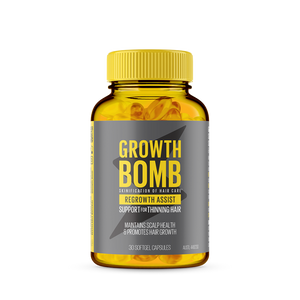 A bottle of Growth Bomb USs Regrowth Assist Support for Thinning Hair Supplement with a yellow label promotes hair growth and scalp health. Maintain thick hair with 30 nourishing softgel capsules designed to support thinning hair.