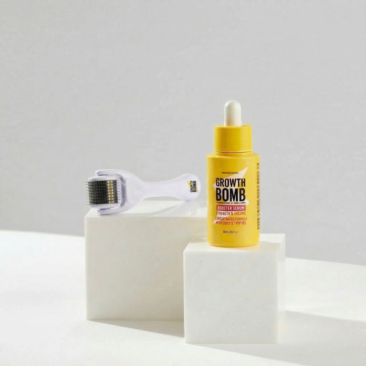 Hair growth serum bottle with dropper and white scalp roller attachment