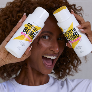 Two hair care bottles held near face with yellow and black Growth Bomb labels